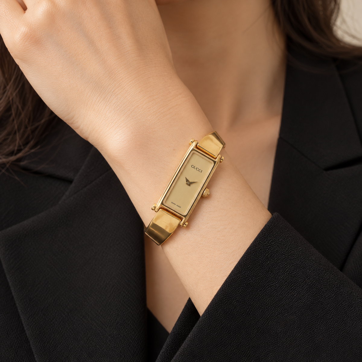 AI-generated styling illustration of Gucci 1500L Bangle Quartz Watch — Gold Tone & Champagne Dial; refer to actual item photo for condition and dimensions
