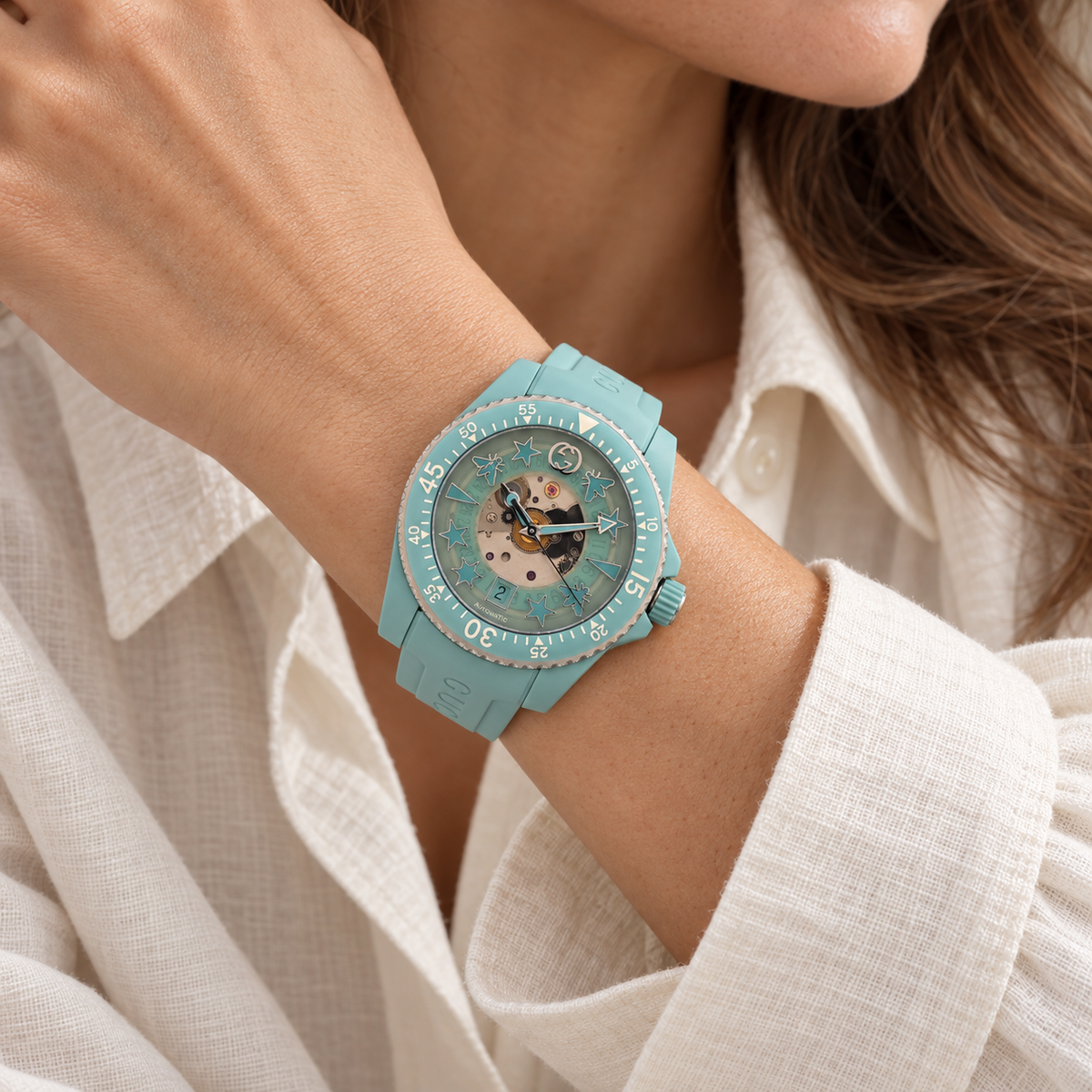 AI-generated styling illustration of Gucci Dive 136.3 Automatic Skeleton Watch — Aquamarine; refer to actual item photo for condition and dimensions