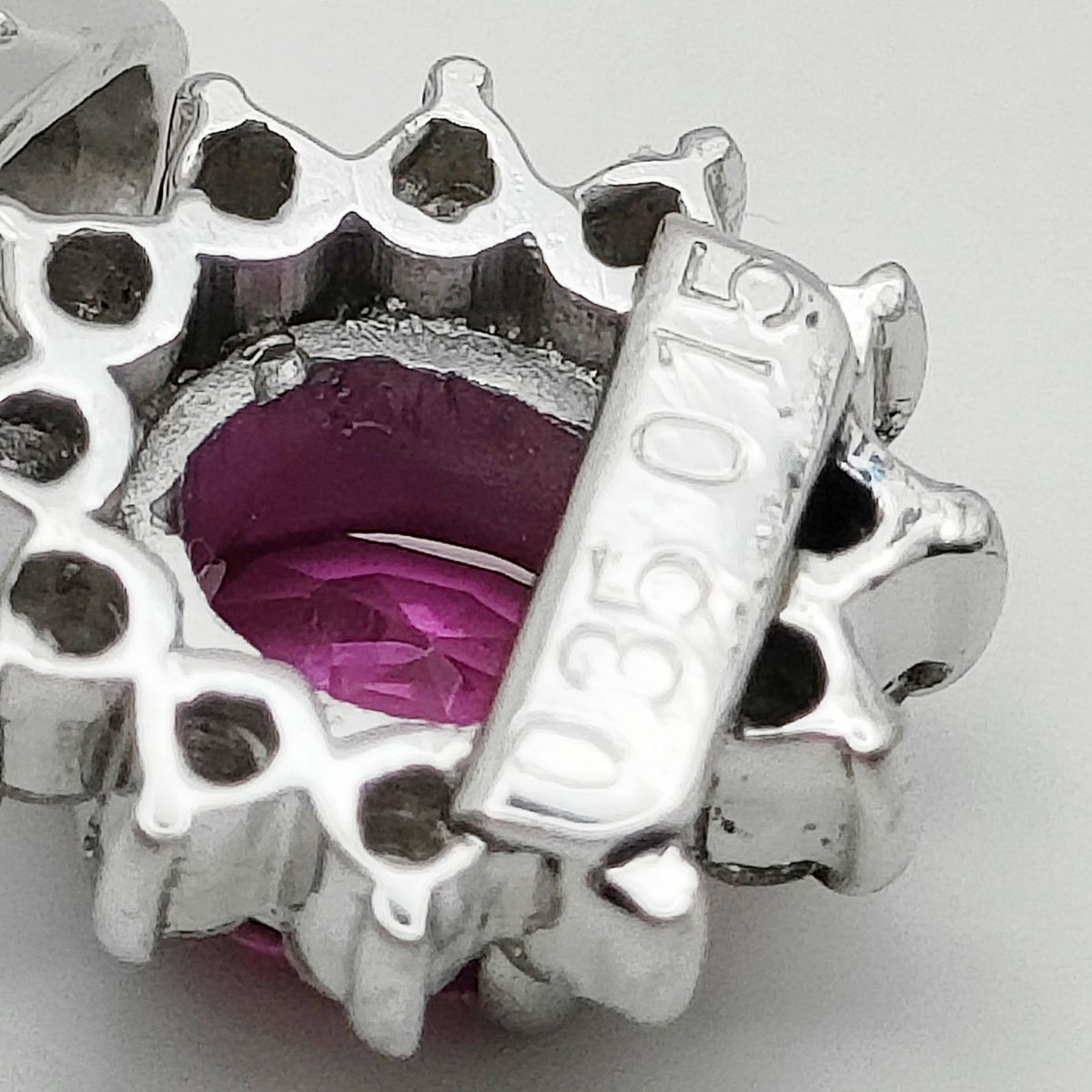 Platinum ruby and diamond halo pendant hallmark