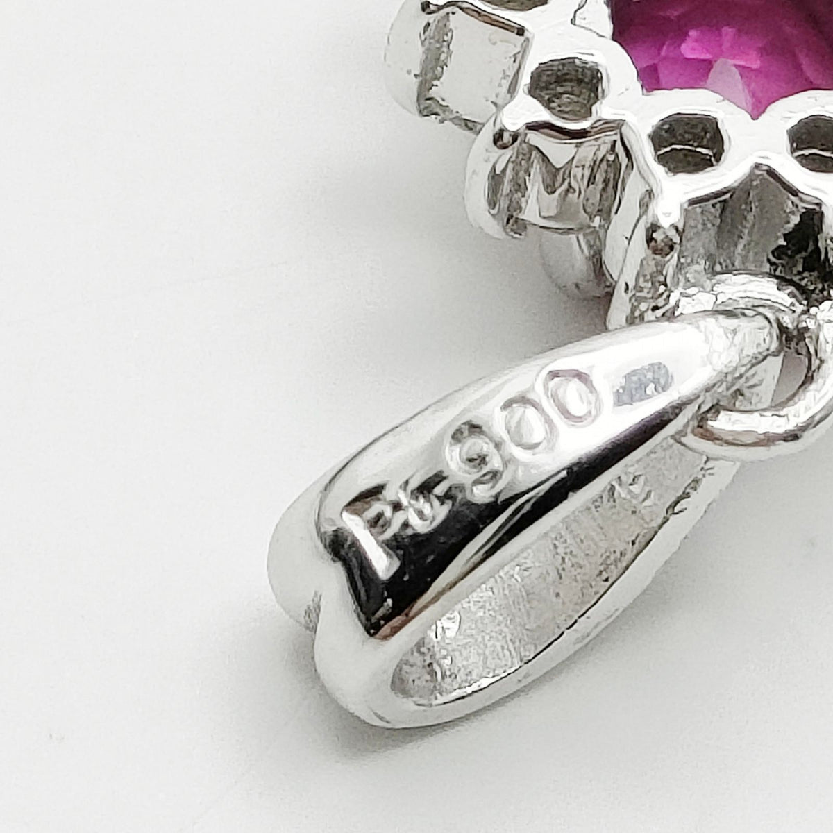 Platinum ruby and diamond halo pendant platinum mark