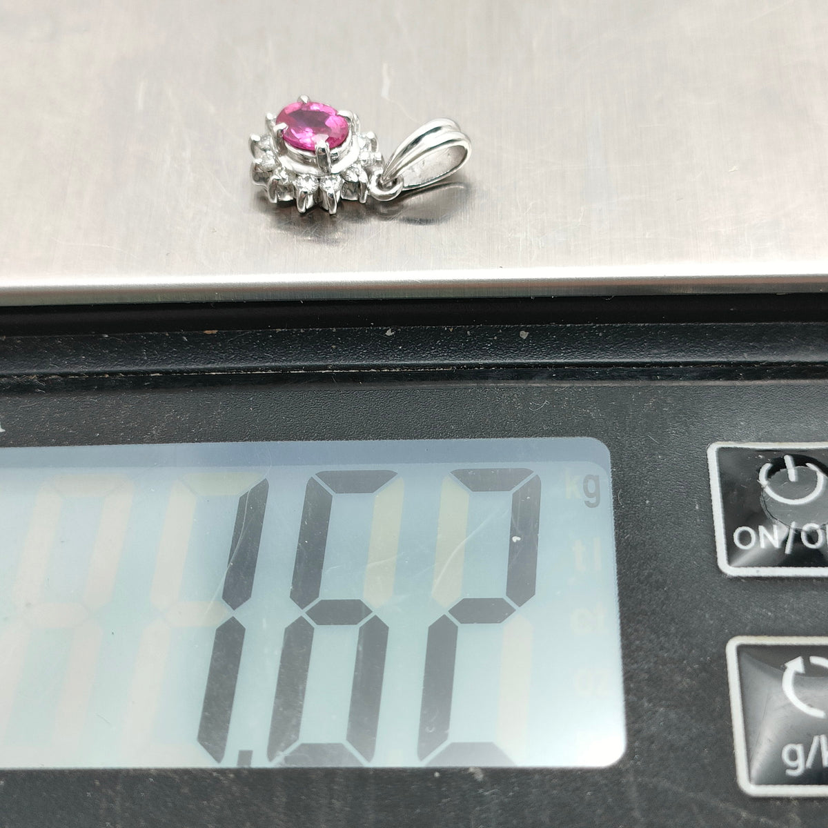 Platinum ruby and diamond halo pendant weight